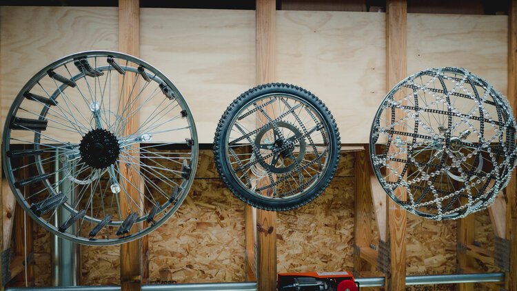 Different bicycle part chandeliers hang in Acosta's studio.