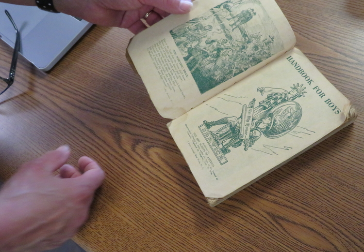 Fournier thumbing through a vintage book in her collection.