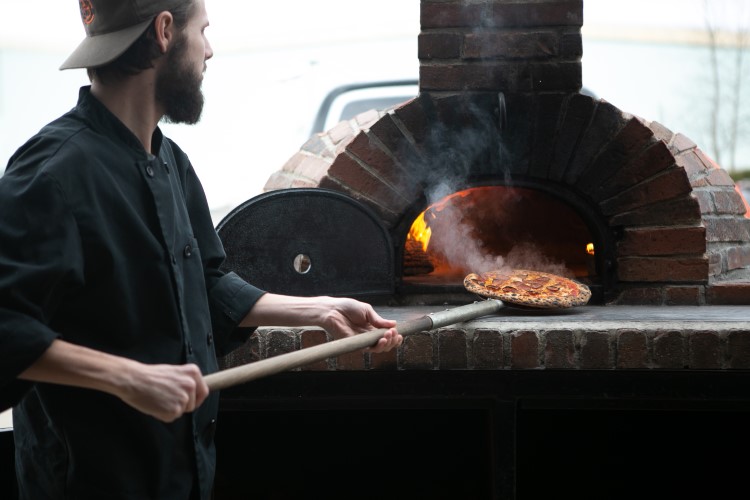 Pizza Baker makes artisan, wood-fired pizzas and has a devout following they have built from a food truck.