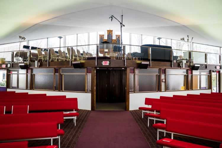 The original pews were recently stripped down and re-finished, restoring them to their original vibrancy.