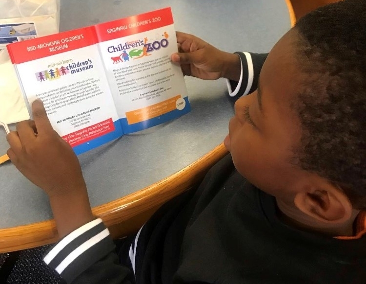 A student with his new STEM Passport at Herig Elementary in the Saginaw.