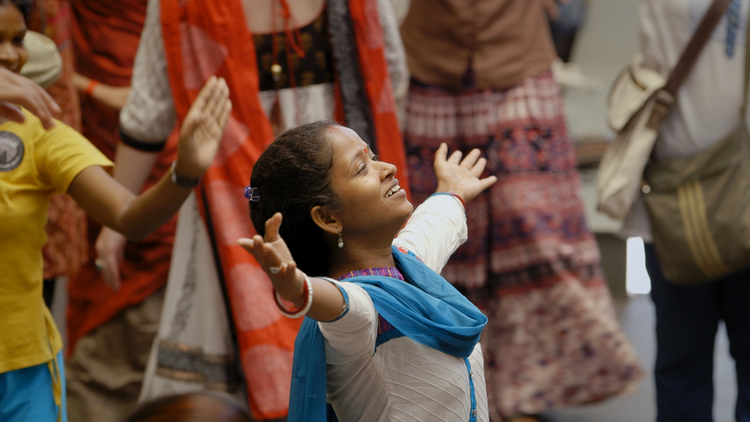 Senior Dance Movement Therapy Practitioner Jhulan Mondal leads a group dance at Kolkata Sanved’s 10th Anniversary Celebration in the documentary Little Stones.