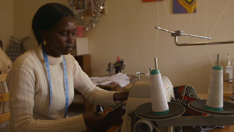 Kenyan tailor Judith Achiemg Dgaye sews a skirt for the clothing line Judith & James, in the documentary Little Stones.