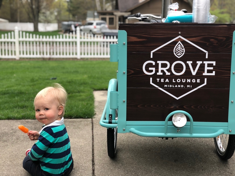 A little Grove Tea Lounge fan next to the cafe's cart.