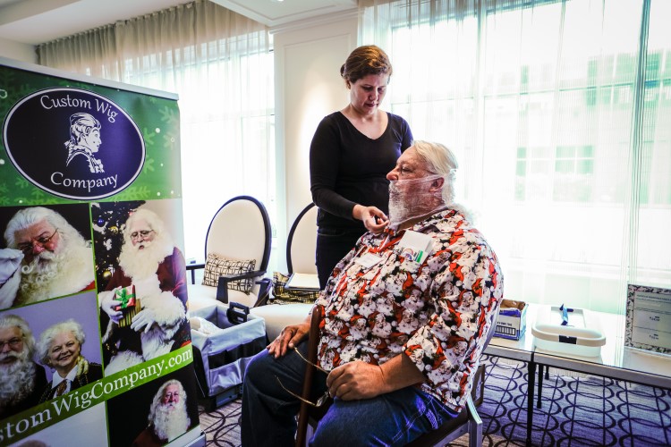 One of Santa's cousins getting fitted for his beard.