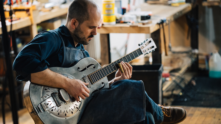 Matt Eich, owner of Mule Resophonic Guitars playing a finished product.