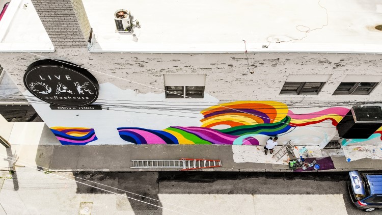 The side of Live Oak Coffeehouse transforms with the mural currently underway.