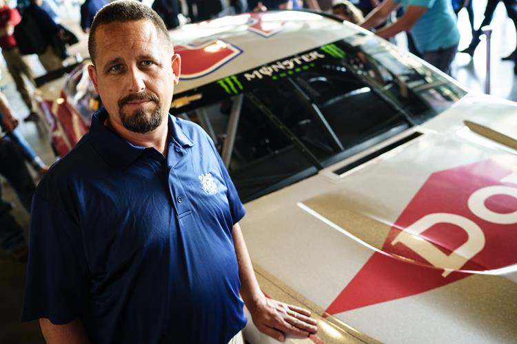 Ryan Ellis of Dow with the newly unveiled stock race car.