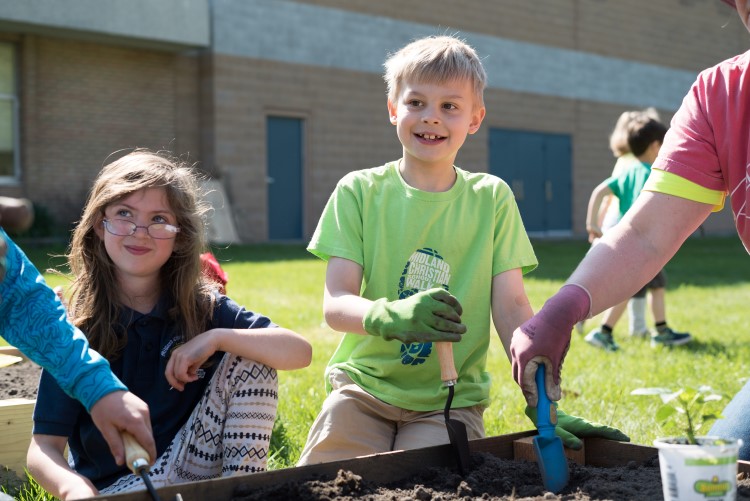 Children at Midland Christian helping get planting underway in May.