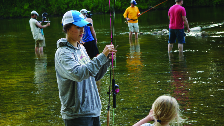 Anglers of all ages participating in a fishing demo in Midland