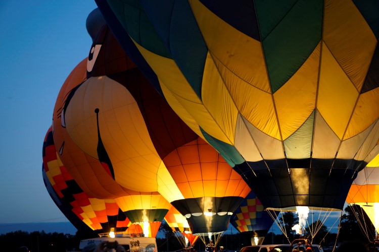 Hot air balloons lined up at sunset in Midland