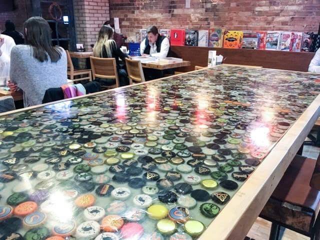 The custom beer cap table at Whichcraft Taproom
