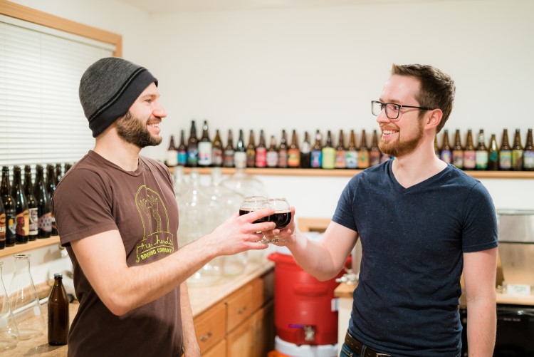 Thomas and Vagnini cheers in the duo's tasting room