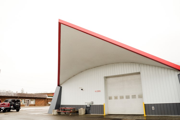 Auto Perfection occupies a unique building, with a striking rooftop that forms an awning at each corner of the structure.