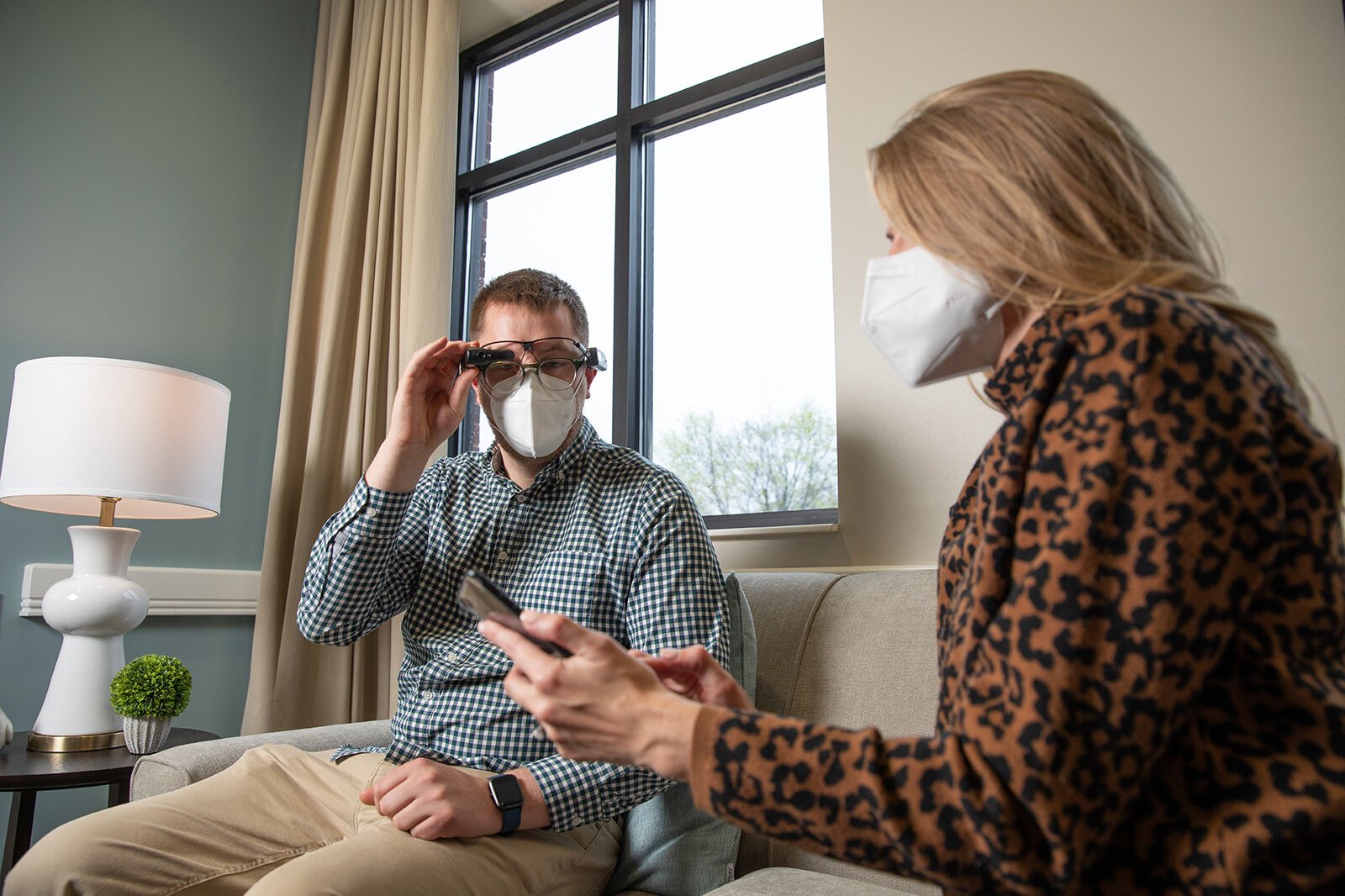 Dayna Roe, Samaritas director of memory care, demonstrates smart glasses with a colleague.
