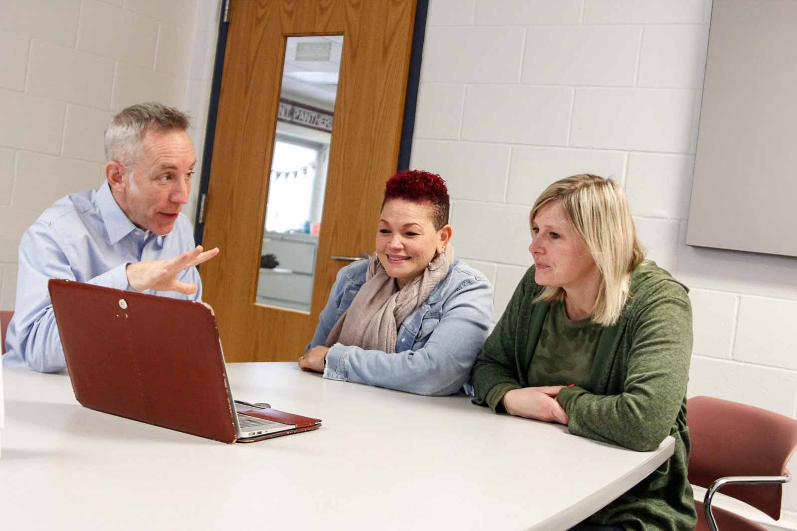 Ethan Alexander, Behavior Specialist Marcy Carter, and Principal Lindsey Newton confer at Kalamazoo's Northwood Elementary.