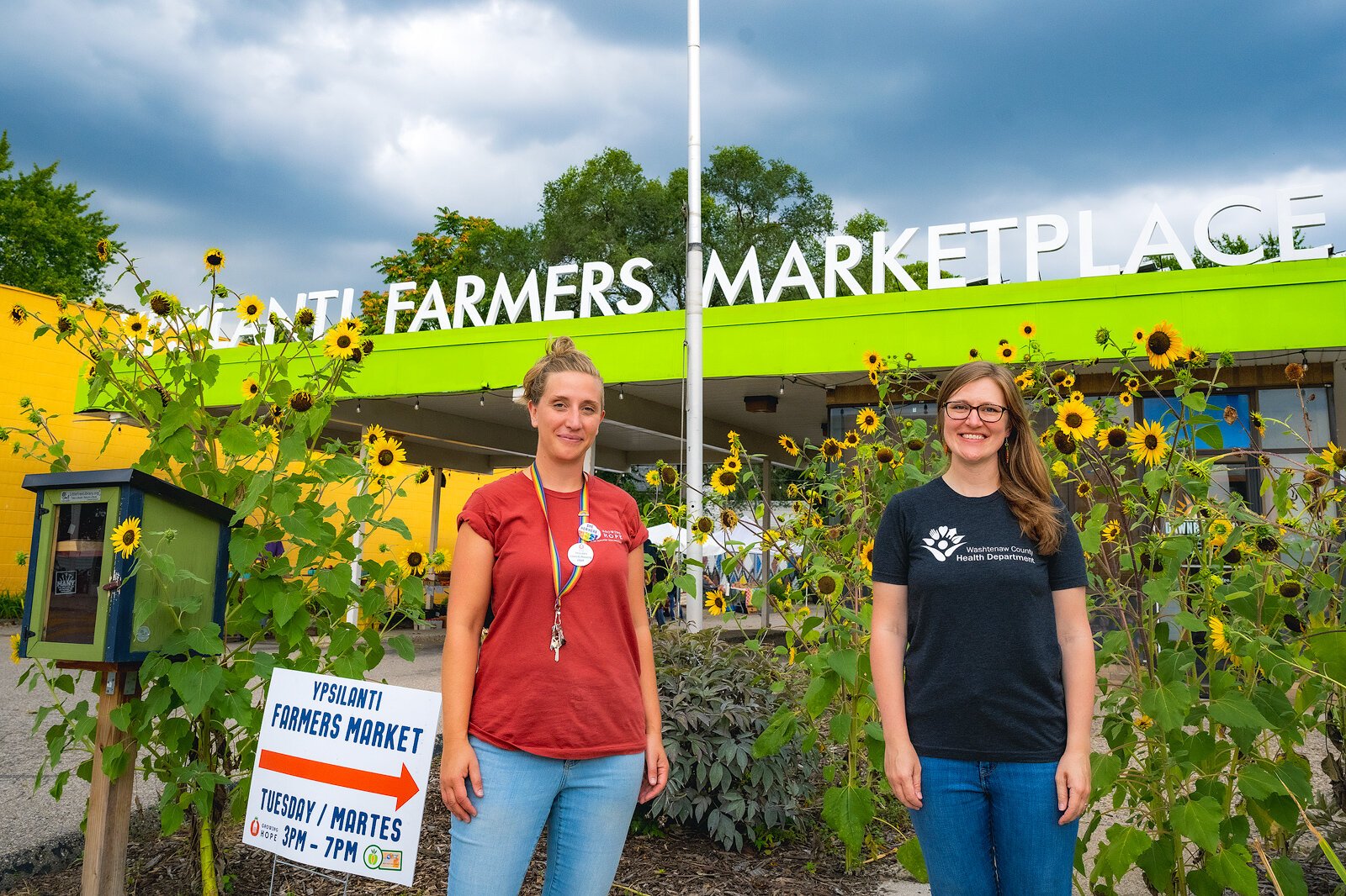 Dayna Popkey, Ypsilanti Farmers Market manager and nutrition manager; and Ariane Donnelly, Washtenaw County Health Department health promotion coordinator, at the Ypsilanti Farmers Marketplace.