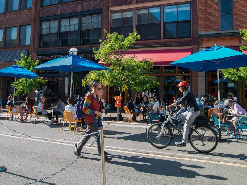 People walk and bike down Washington Street in Ann Arbor.