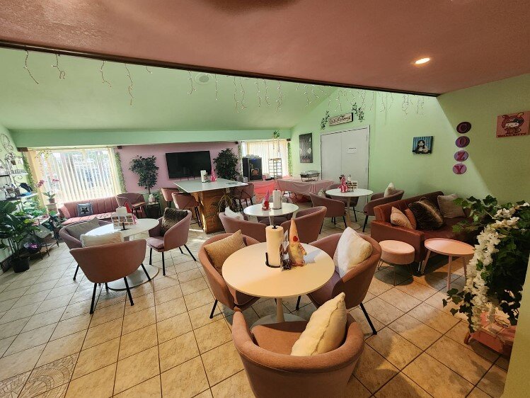 The dining area of the Cozy Cats Cafe.