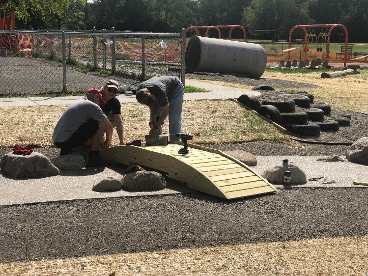  Kiwanis team building bridge on playground at Longview.