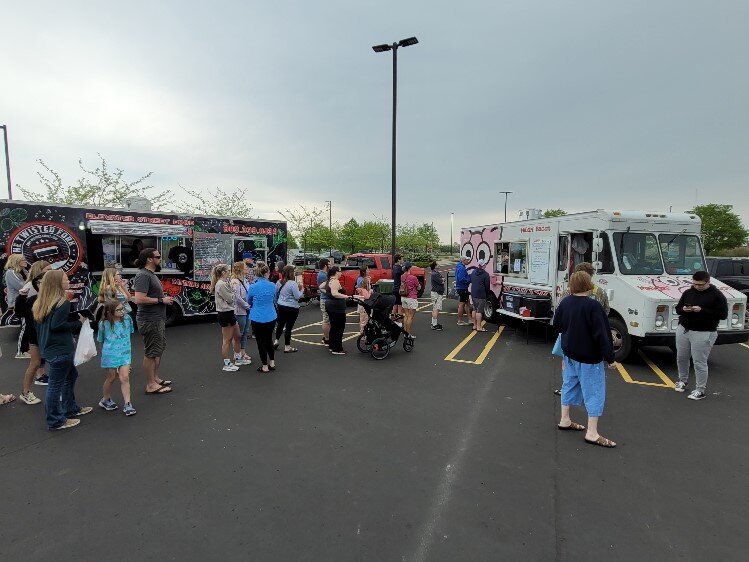 Food trucks serve breakfast and lunch at the market.