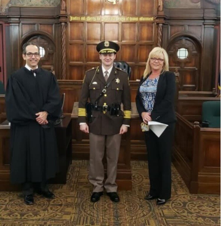 Sheriff Myron Greene at his swearing-in ceremony with Judge Stephen Carras and Midland County Clerk Ann Manary