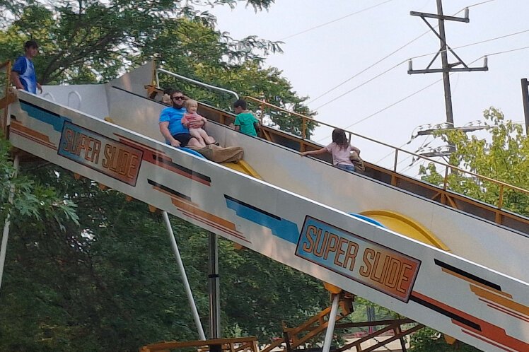Adults and kids enjoy the Super Slide at River Days