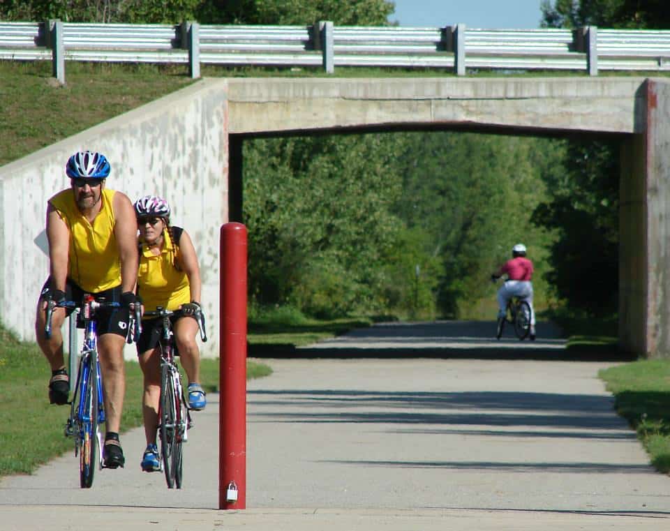 Bikers riding under bridge