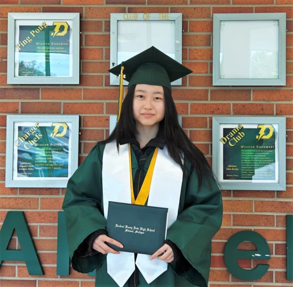 Graduate holding her diploma