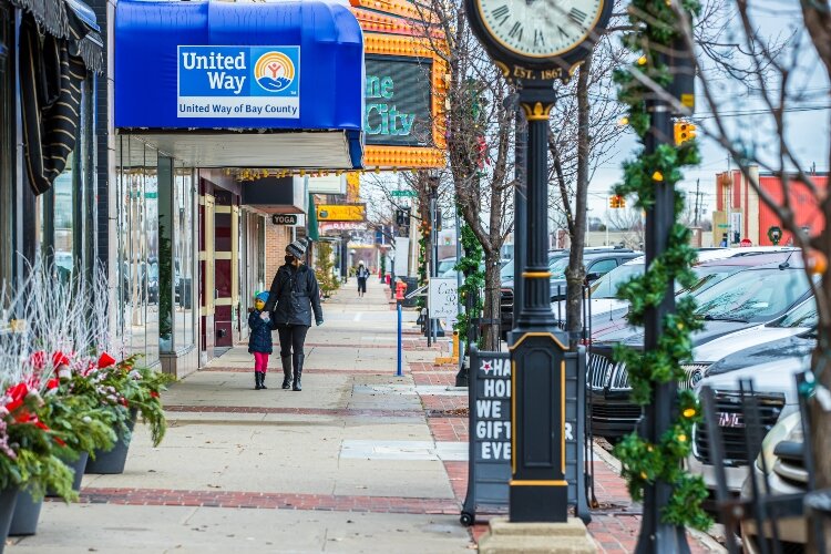 Garland and poinsettias add color to outdoor displays.