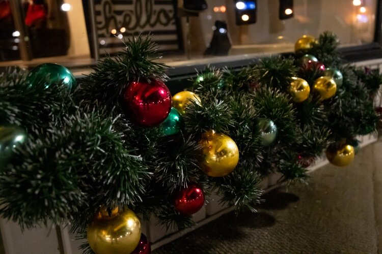 Evergreen boughs, ornaments, and lights fill the stores and homes throughout the downtown district.