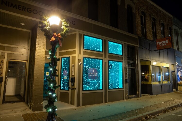 Holiday displays light up the windows of the Village Chocolatier, 811 Saginaw St. .