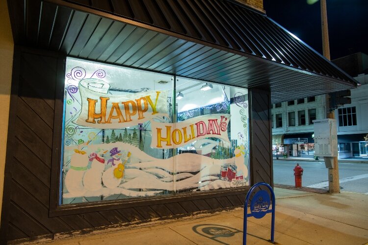 Holiday greetings fill the windows at Herter Music Center, 901 Washington Ave.