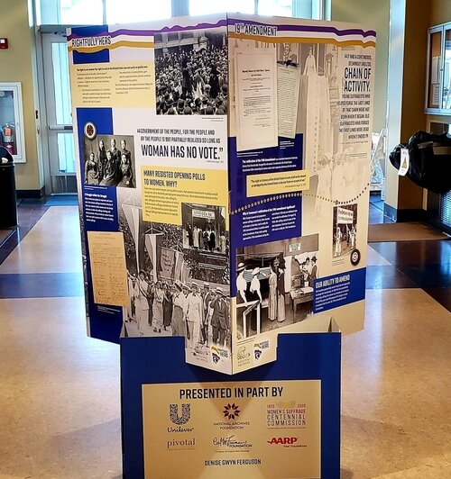 A four-panel display near the entry of the Alice and Jack Wirt Public Library explains the history of how women won the right to vote and why voting rights struggles still persist. The display is presented by the Nation Archives Foundation.