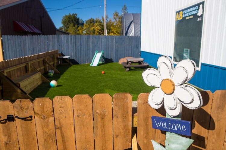 Tristan Dean, assistant to the property manager at Game Changer Pediatric Therapy Services, helped build this outdoor space for patients. Birdhouses and flower boxes decorate the space.