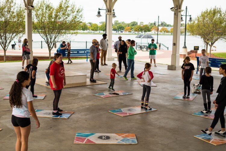 Dancers gather under the Nickless Family Community Pavilion for the Downtown Shuffle Around on Sept. 12. The tap dance boards were spaced out in order to keep everyone appropriately distanced.