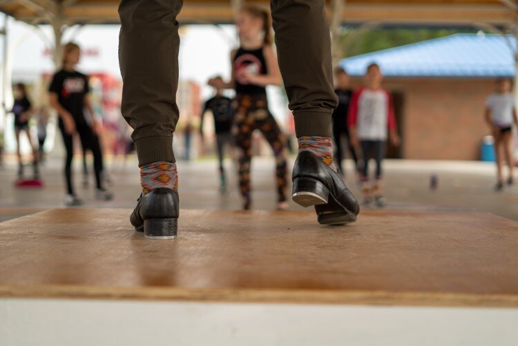 Ryan VanDenBoom demonstrated the roots of modern tap dancing, showing students how the moves evolved from Irish and African American traditions.