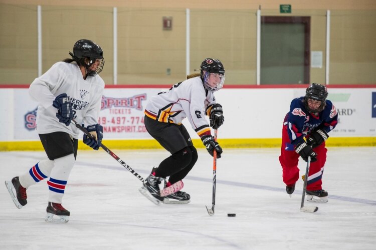 Increasing numbers of women are playing ice hockey, traditionally a men-only sport. Amy Guzman, Becca Turner and Tiffany Muylle are three of the women involved in a hockey league playing Wednesdays at the Bay County Civic Arena.