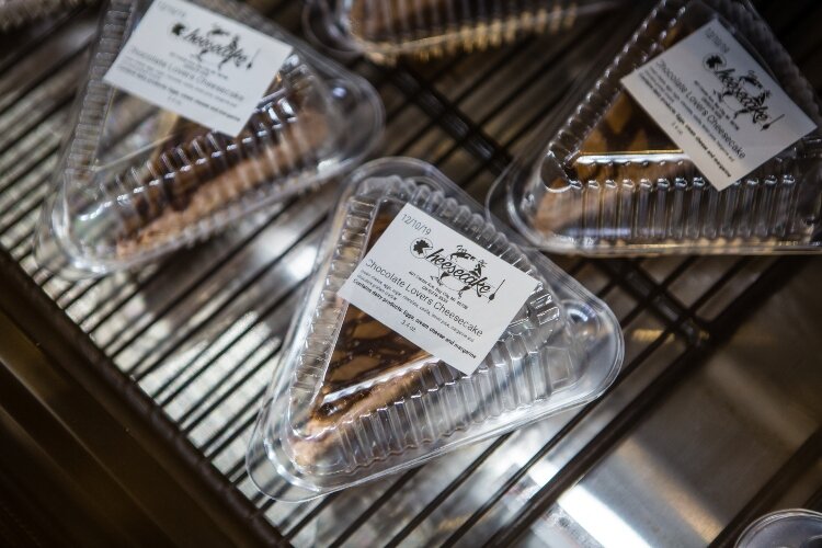 Douglass experiments with flavors to create the toppings for each cheesecake.