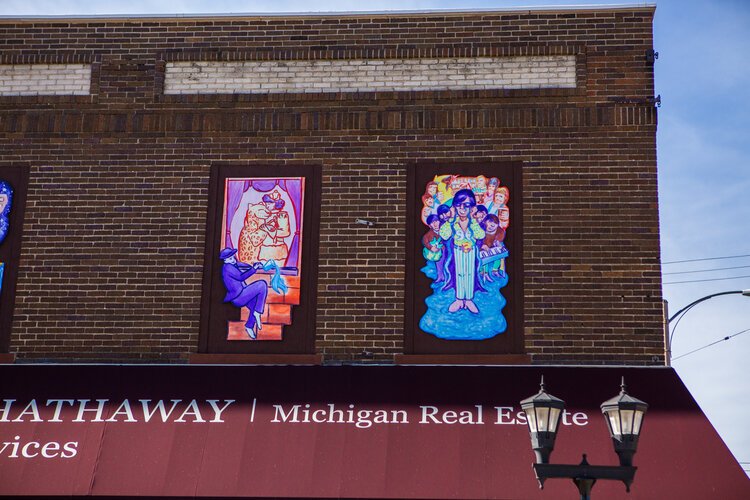 Each panel of this mural tells a different story from Bay City's history, such as a circus trainer who lived above Old City Hall.