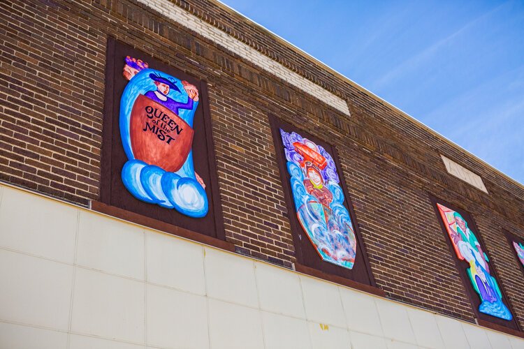 One panel of this mural tells the story of Annie Edson Taylor barreling over Niagara Falls.