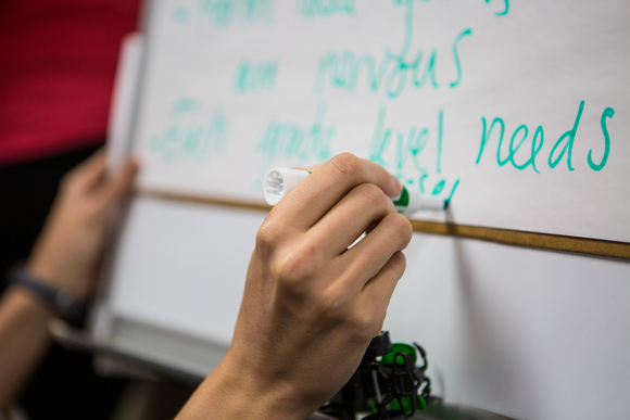 A recorder captures suggestions from the members of the SPIRIT Council.