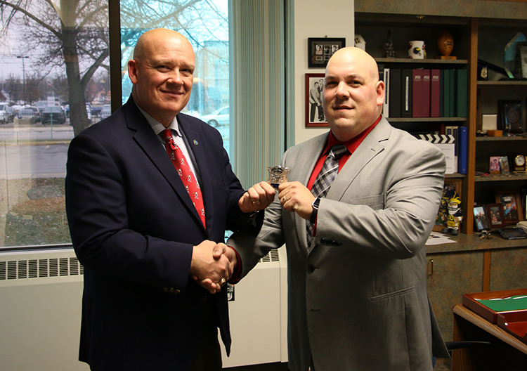 Michael Cecchini (left) promotes Officer Todd Armstrong to Sergeant