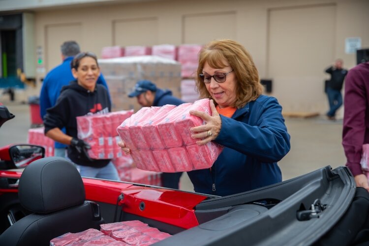 Throughout the morning, cars and trucks pulled into the McGraw Street location to fill up with donated sugar.