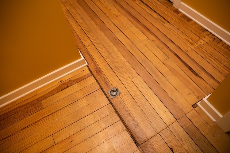 Barely noticeable in the floor is an old trap door that used to have hinges and a pulley system that hoisted the buggies up for storage.