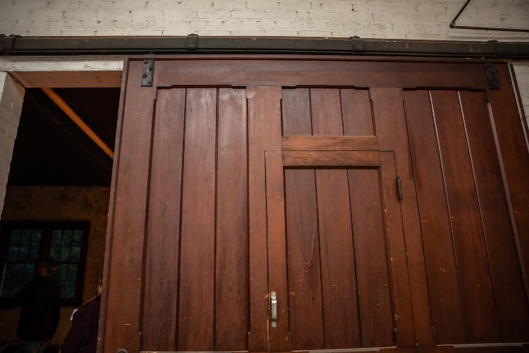 They brought one of the large sliding barn doors into an upstairs living space to divide it from the bedrooms.