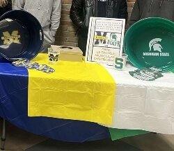 Students sold paper footballs before the UM-MSU face-off earlier this month. The sales showed the University of Michigan to be the favorite while raising over $100 for MDA.