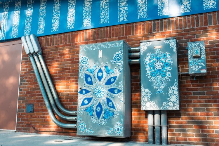 Blue and white flowers on the side of the World Friendship Shell honor the community's Polish heritage.