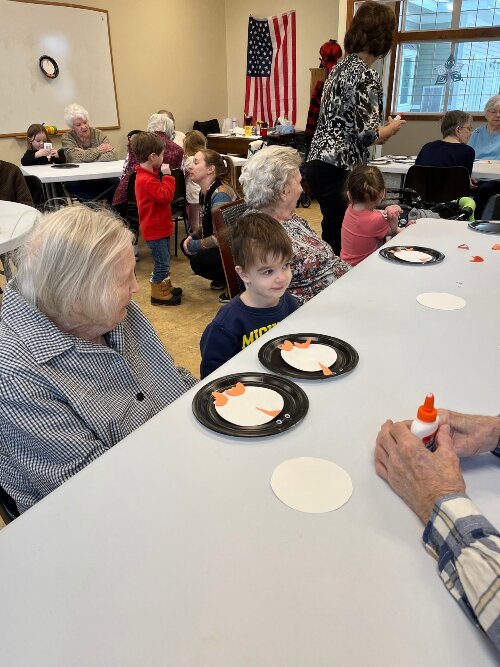 As soon as the pre-schoolers hear they get to visit the senior center, they start working on coloring pictures to give to the seniors.
