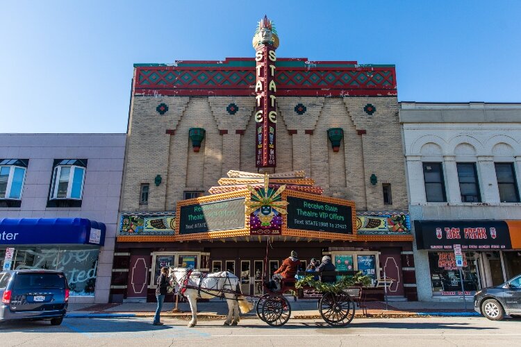 Horse-drawn sleighs take families on tours of the downtown decorations.